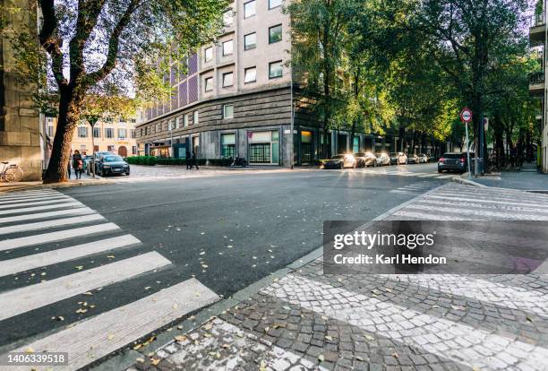 a daytime view of streets in milan, italy - calle fotografías e imágenes de stock