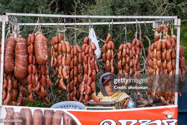 woman selling turkish sucuk sausage made from camel meat - halal butcher shop stock pictures, royalty-free photos & images
