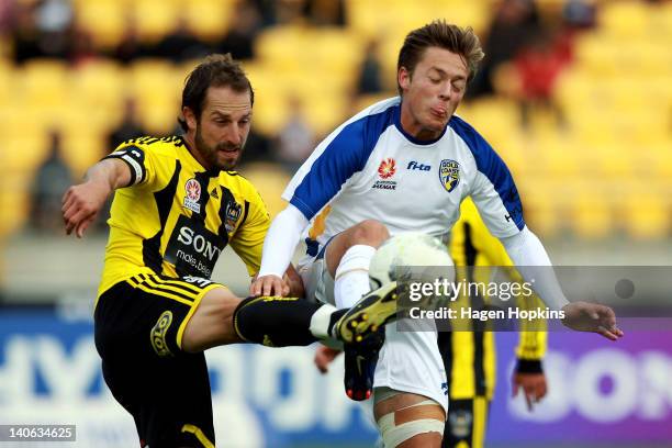 Andrew Durante of Wellington competes for the ball with Chris Harold of Gold Coast during the round 22 A-League match between Wellington Phoenix and...