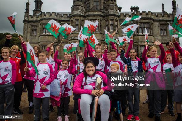 Baton bearers pose for a photo outside Margam Castle the Queen's Baton during the Birmingham 2022 Queen's Baton Relay at a visit to Margam Park on...