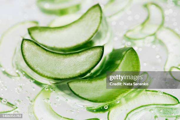 aloe vera slice texture with gel on green background. - aloe vera gel stock pictures, royalty-free photos & images