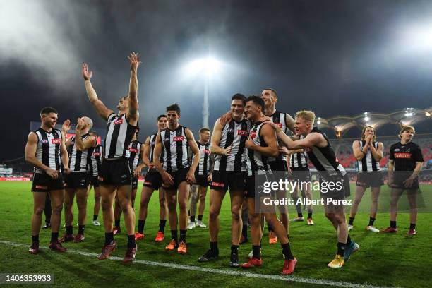 Collingwood Magpies celebrate victory during the round 16 AFL match between the Gold Coast Suns and the Collingwood Magpies at Metricon Stadium on...