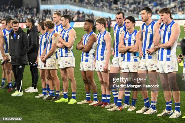Kangaroos players react following the round 16 AFL match between the Geelong Cats and the North Melbourne Kangaroos at GMHBA Stadium on July 02, 2022...