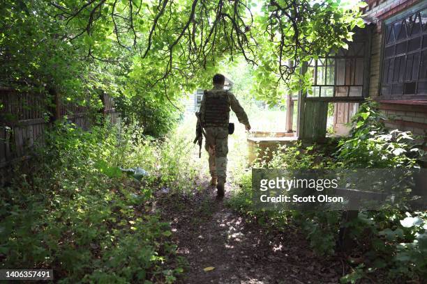 Soldier with Ukraine's Territorial Defense walks up to an abandoned home on June 29, 2022 in the Kramatorsk Region, Ukraine.Territorial Defense units...