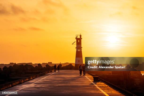 lighthouse in praia da barra at sunset, ilhavo, portugal - golden hour beach stock pictures, royalty-free photos & images