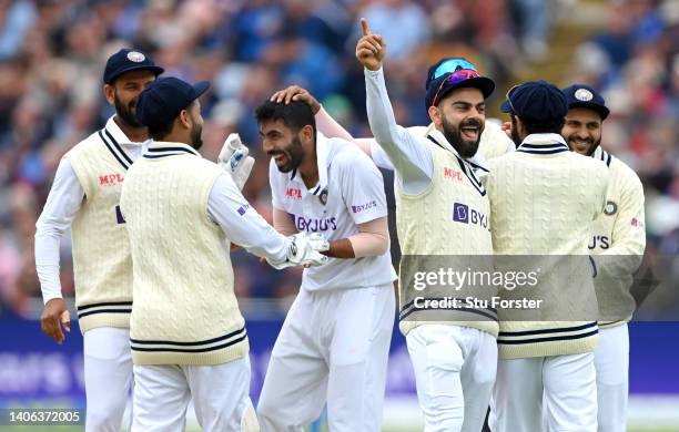 India bowler Jasprit Bumrah celebrates with team mates as Virat Kohli reacts after taking the wicket of OlliePope during day two of the Fifth test...