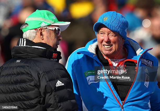 Uwe Muessiggang , head coach of the German Biathlon team talks to Wolfgang Pichler , head coach of the Russian Biathlon team during the women's 7,5km...