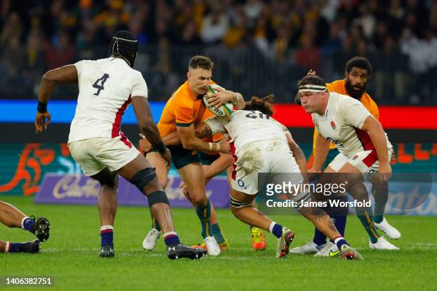 Nic White of the Wallabies gets tackled by Lewis Ludlam of England during game one of the international test match series between the Australian...