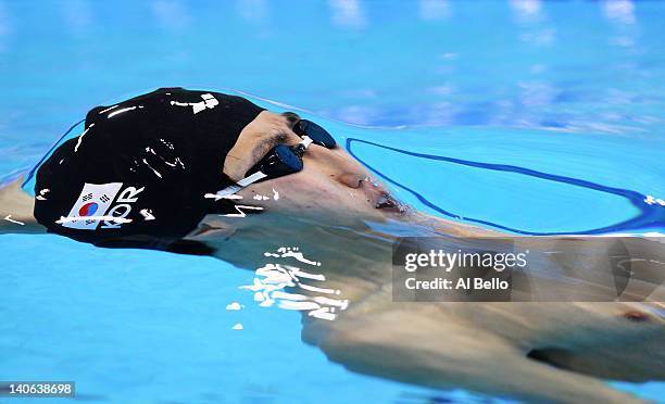Joonho Kim of Korea competes in the Mens 100m Backstroke heat 9 during day two of the British Gas Swimming Championships at The London Aquatics...