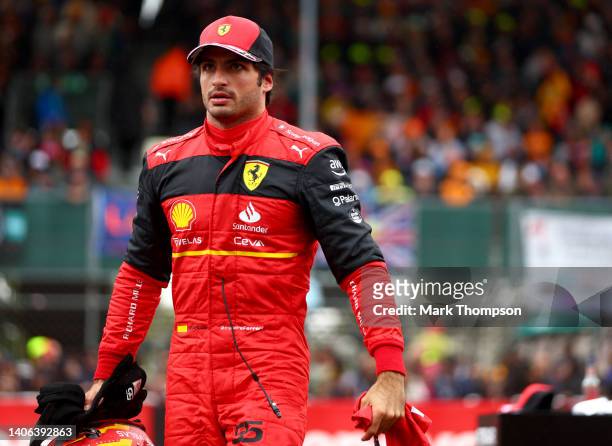 Pole position qualifier Carlos Sainz of Spain and Ferrari looks on in parc ferme during qualifying ahead of the F1 Grand Prix of Great Britain at...