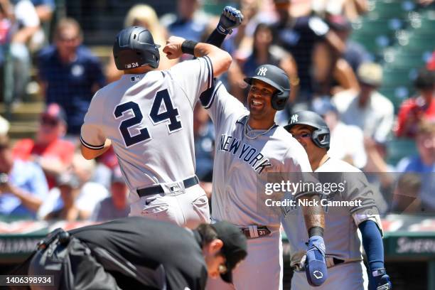 Aaron Hicks and Matt Carpenter of the New York Yankees celebrate scoring on a two-run home run by Carpenter off Anthony Gose of the Cleveland...