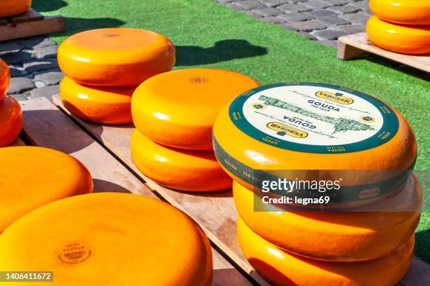 traditional dutch cheese with orange coating - gouda stock pictures, royalty-free photos & images