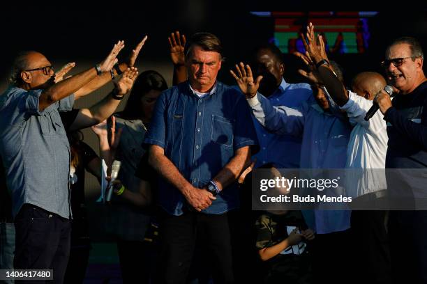 President of Brazil Jair Bolsonaro receives a blessing during a music festival organized by a local evangelic radio station on July 02, 2022 in Rio...