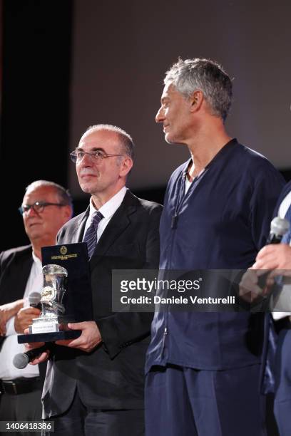 Giuseppe Tornatore, with the "Taormina Arte Award" and Rosario Fiorello are seen on stage during the Taormina Film Fest 2022 on July 02, 2022 in...