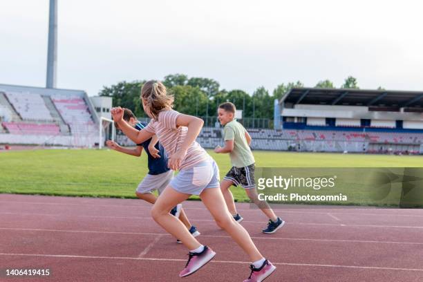 children running race - kids track and field stock pictures, royalty-free photos & images