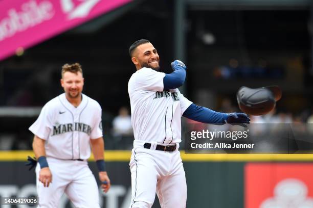 Abraham Toro of the Seattle Mariners tosses his helmet after hitting the game winning RBI single during the ninth inning against the Oakland...