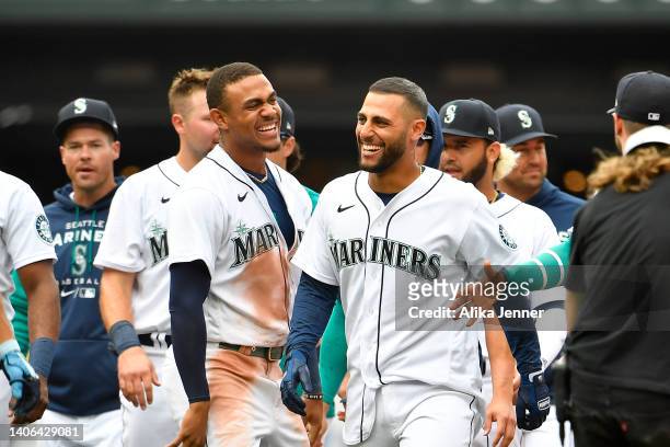 Abraham Toro of the Seattle Mariners celebrates with teammates after hitting the game winning RBI single during the ninth inning against the Oakland...