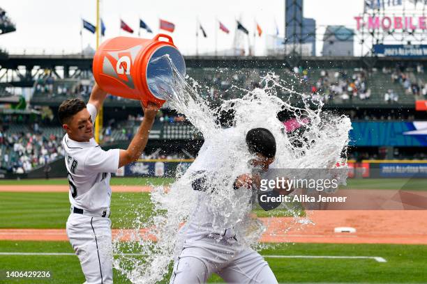 Abraham Toro of the Seattle Mariners gets doused with water by Adam Frazier after hitting the game winning RBI single during the ninth inning against...