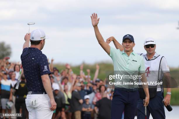 Carlos Ortiz of Fireballs GC celebrates making his putt on the 18th green alongside Branden Grace of Stinger GC and caddie Austin Johnson during day...