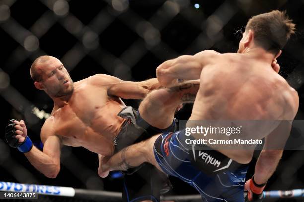 Donald Cerrone exchanges strikes with Jim Miller in their welterweight bout during UFC 276 at T-Mobile Arena on July 02, 2022 in Las Vegas, Nevada.