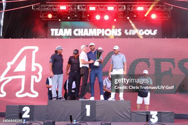 Greg Norman, CEO and commissioner of LIV Golf, awards the team trophy to Team Captain Dustin Johnson of 4 Aces GC as Pat Perez, Patrick Reed and...