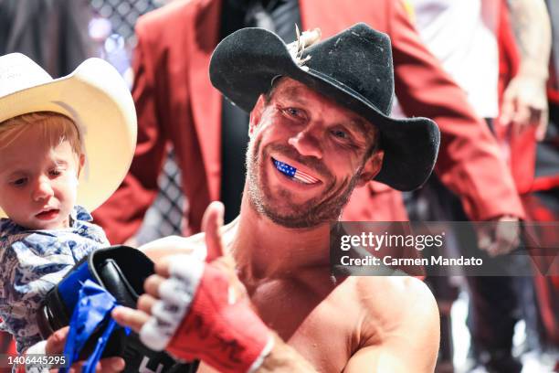 Donald Cerrone and son exit the Octagon during the UFC 276 event at T-Mobile Arena on July 02, 2022 in Las Vegas, Nevada.