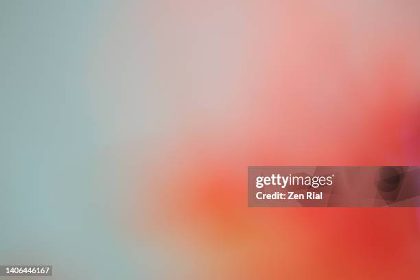 blurry royal poinciana petal creating a smooth blue, pinkish orange abstract image - mühelosigkeit stock-fotos und bilder