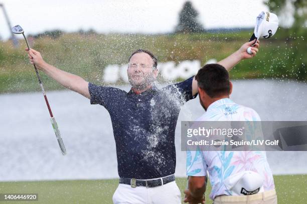 Branden Grace of Stinger GC is sprayed with champagne by Team Captain Louis Oosthuizen of Stinger GC after winning on the 18th green during day three...
