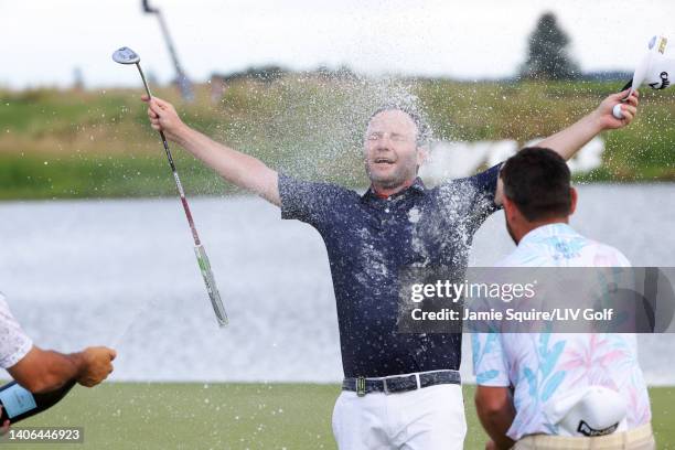 Branden Grace of Stinger GC is sprayed with champagne by Team Captain Louis Oosthuizen of Stinger GC after winning on the 18th green during day three...