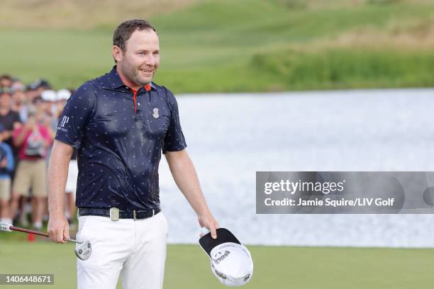 Branden Grace of Stinger GC is seen doused in champagne after winning on the 18th green during day three of the LIV Golf Invitational - Portland at...