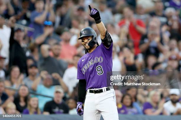 Connor Joe of the Colorado Rockies celebrates on third base after hitting a 3 RBI triple against the Arizona Diamondbacks in the fourth inning at...