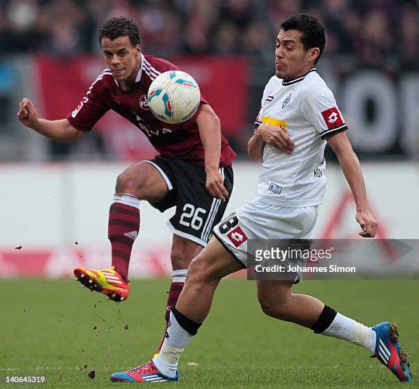 Timothy Chandler of Nuernberg battles for the ball with Juan Arango of Moenchengladbach during the Bundesliga match between 1.FC Nuernberg and...