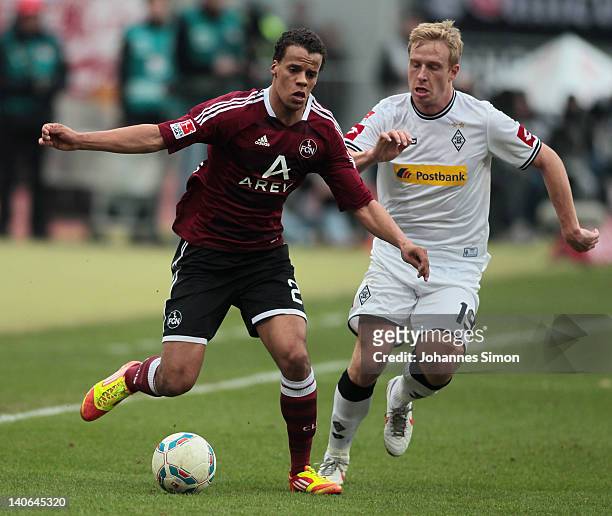 Timothy Chandler of Nuernberg battles for the ball with Mike Hanke of Moenchengladbach during the Bundesliga match between 1.FC Nuernberg and...