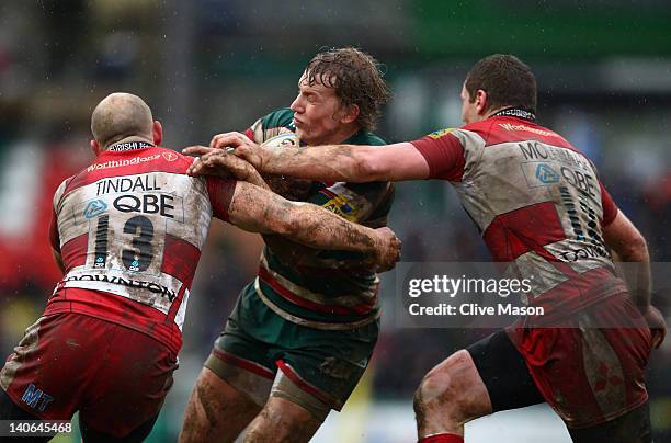 Billy Twelvetrees of Leicester Tigers is tackled by Mike Tindall of Gloucester during the Aviva Premiership match between Leicester Tigers and...