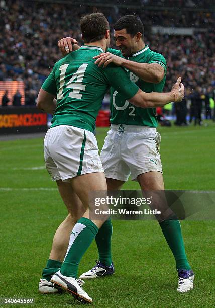 Tommy Bowe of Ireland is congratulated by team mate Rob Kearney after scoring his second try during the RBS Six Nations match between France and...