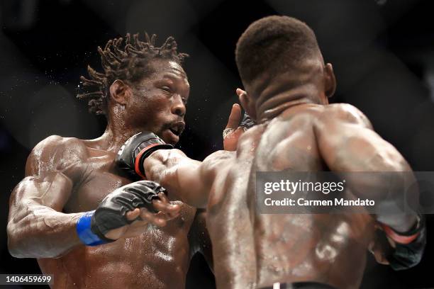 Israel Adesanya of Nigeria punches Jared Cannonier in their middleweight title bout during UFC 276 at T-Mobile Arena on July 02, 2022 in Las Vegas,...