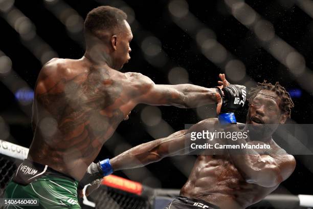 Israel Adesanya of Nigeria punches Jared Cannonier in their middleweight title bout during UFC 276 at T-Mobile Arena on July 02, 2022 in Las Vegas,...