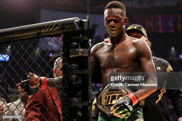 Israel Adesanya of Nigeria exits the octagon after his unanimous decision win over Jared Cannonier in their middleweight title bout during UFC 276 at...