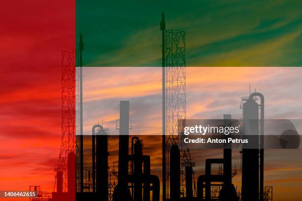 oil refinery plant on the background of the uae flag - middle east oil stock pictures, royalty-free photos & images