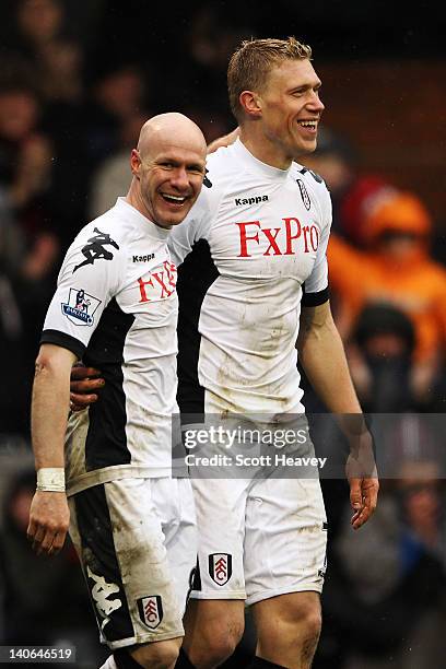 Fulham's Pavel Pogrebnyak is congratulated by teammate Andrew Johnson after he scores his third goal of the match during the Barclays Premier League...