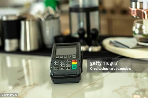 payment with credit card swipes through the terminal. customer paying with edc machine. buy and sell products or services in a cafe - kreditkartenlesegerät stock-fotos und bilder