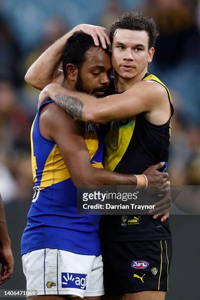 Willie Rioli of the Eagles and Daniel Rioli of the Tigers embrace after the round 16 AFL match between the Richmond Tigers and the West Coast Eagles...