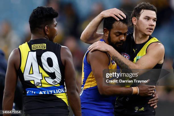 Willie Rioli of the Eagles and Daniel Rioli of the Tigers embrace after the round 16 AFL match between the Richmond Tigers and the West Coast Eagles...