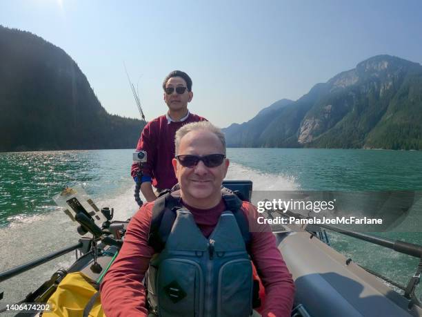 multiracial 60+ senior friends riding boat to go freshwater fishing - bc commercial fishing boats stock pictures, royalty-free photos & images