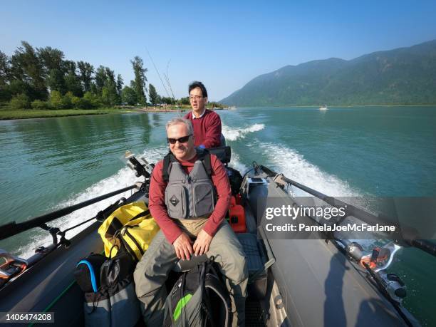 60+ multiracial senior friends riding in boat to go fishing - bc commercial fishing boats stock pictures, royalty-free photos & images