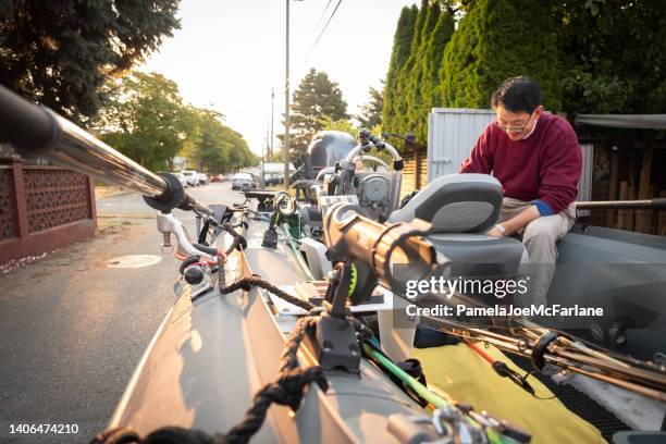 60+ asian man preparing boat to go fishing, early morning - bc commercial fishing boats stock pictures, royalty-free photos & images