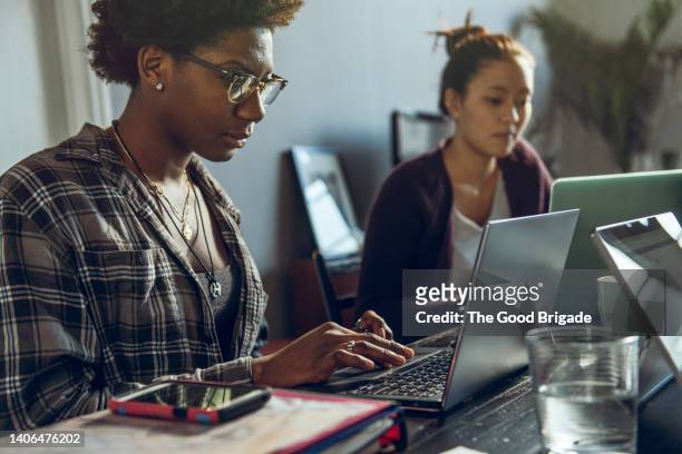 female friends studying together at home - coding laptop stock pictures, royalty-free photos & images