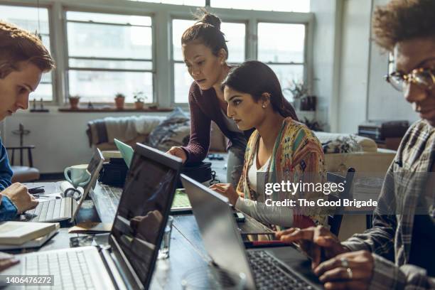 young friends studying on laptop together in living room - indian community stock pictures, royalty-free photos & images