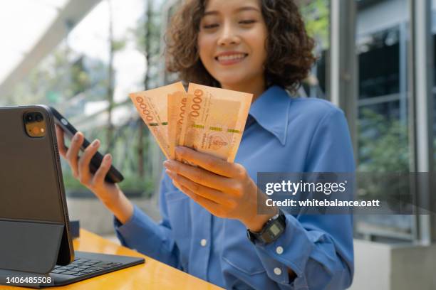 business woman counting thai money - thai currency stock pictures, royalty-free photos & images
