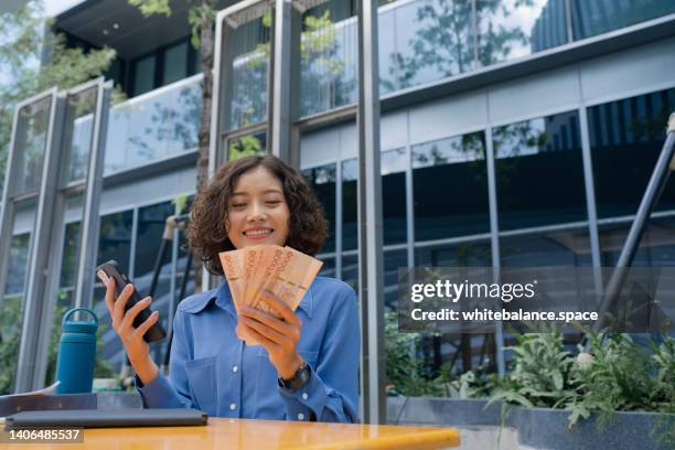 business woman counting thai money - north korean money stock pictures, royalty-free photos & images